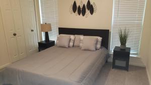 a bedroom with a bed with white sheets and pillows at Elegant 2Bed & 2 Bath Comfort in Dallas +24 photos