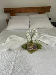 a white bed with a valentines bow on it at Bungalows Chachagüita in Fortuna