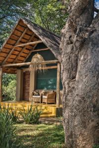 a house with a couch in the yard at Thornicroft Lodge - South Luangwa in Mfuwe