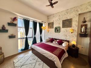 a bedroom with a bed and a large window at Royal Moroccan Escape in Noida in Noida +59 photos