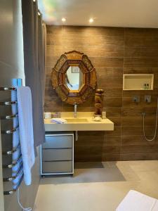 a bathroom with a sink and a mirror at Restau de Marambaia in Barra de Guaratiba +32 photos