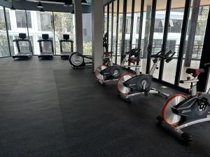 a gym with several treadmills and elliptical machines at Bellevue Lagoon Phuket in Laguna Phuket