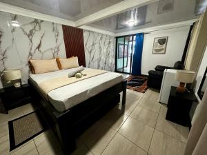 a bedroom with a large bed in a room at Caribbean View House in Tortuguero
