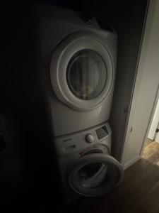 a washing machine in a bathroom with a toilet at Next rental in Vernon