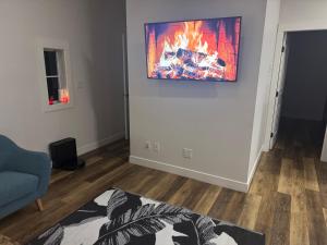a living room with a fire on the wall at Next rental in Vernon