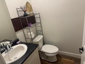 a bathroom with a toilet and a sink at Next rental in Vernon