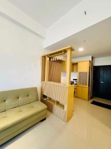 a living room with a couch and a kitchen at Azure Luxury Apartment Luxury Stay Near Airport Negombo in Negombo