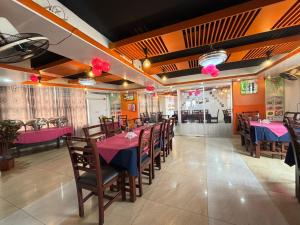 a dining room with tables and chairs and pink decorations at Hotel Progati Inn Ltd. in Dhaka
