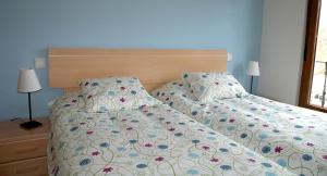 a bedroom with two beds and two lamps at Apartamentos Costa Costa in Suances