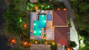 an overhead view of a house with a pool at night at Bahia Pez Vela Resort in Ocotal