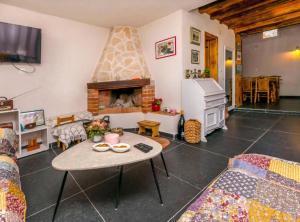 a living room with a table and a fireplace at Holiday home Kuzmino in Primošten