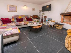 a living room with a couch and a table at Holiday home Kuzmino in Primošten