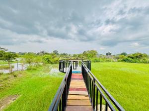 a boardwalk over a river with a bridge at LEOPARD One Villa in Gotamegama +27 photos