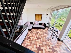 a living room with a couch and a table at LEOPARD One Villa in Gotamegama