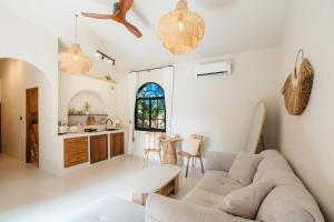 a living room with a couch and a table at Botanica Villas Koh Chang by Indie Beach in Ban Khlong Kloi
