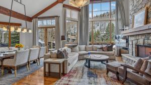 a living room with a couch and a fireplace at Bergrose Lodge in Vail