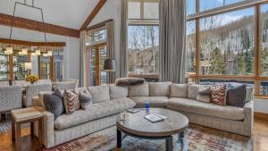 a living room with a couch and a table at Bergrose Lodge in Vail