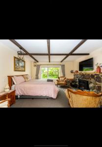 a bedroom with a bed and a stone wall at The old shearers quarters in Glentunnel