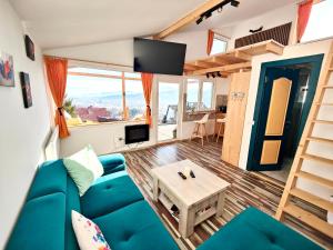 a living room with a blue couch and a table at Rainbow Chalet in Bran