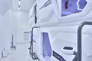 a white hospital room with a toilet in it at Kalion Capsule and Boutique Hotel in Almaty +46 photos