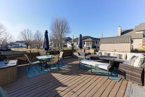 a wooden deck with tables and chairs and umbrellas at Heart & HomeStay in Ankeny