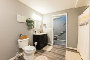 a bathroom with a toilet and a sink at Heart & HomeStay in Ankeny +46 photos