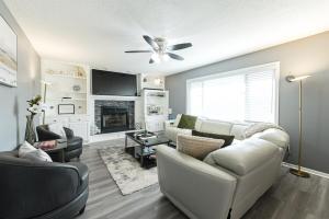 a living room with a white couch and a fireplace at Heart & HomeStay in Ankeny