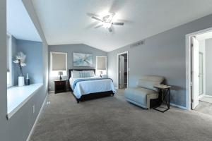 a bedroom with a bed and a ceiling fan at Heart & HomeStay in Ankeny