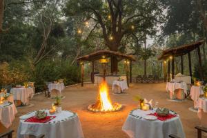 an outdoor wedding with tables and a bonfire at juSTa The Bagh, Kanha in Bhīmlāt +188 photos