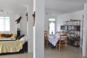 a living room with a table and chairs at Flying Annie Moa in Neiafu