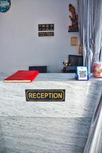 a sign on a bed that says reception at Hotel Relax in Jaipur