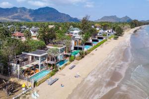 an aerial view of a beach with houses at Let go see the Dolphin Samroiyot in Baanphakrimlay 