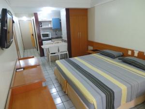 Flat Mobiliado tesisinde bir odada yatak veya yataklar