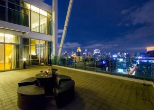 a balcony of a building with a table and chairs at Urbana Sathorn Hotel, Bangkok in Bangkok