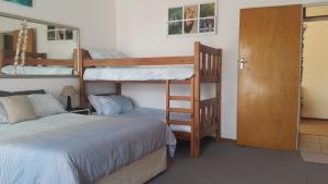 a bedroom with two bunk beds and a ladder at Westcoast Central Budget accommodation in Vredenburg