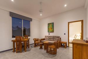 a living room with a couch and a table and chairs at Villa Bentota B24 in Bentota