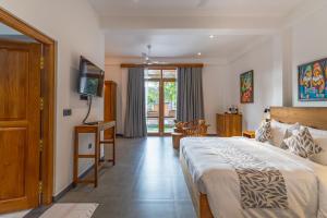 a bedroom with a large bed and a television at Villa Bentota B24 in Bentota +27 photos