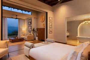 a living room with a large bed and a bathroom at Uga Ghiri - Ella - All Inclusive in Ella +6 photos