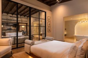 a bedroom with a large white bed and a window at Uga Ghiri - Ella - All Inclusive in Ella