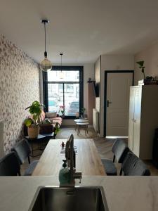 a kitchen and living room with a wooden table at Heiligeweg 48 in Harlingen