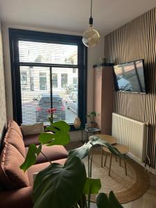 a living room with a couch and a large window at Heiligeweg 48 in Harlingen