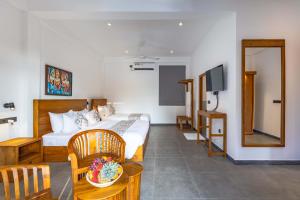 a hotel room with a bed and a television at Villa Bentota B24 in Bentota