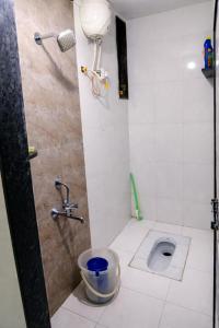 a bathroom with a toilet and a shower at Sukhada Nivas Bunglow in Trimbak +17 photos