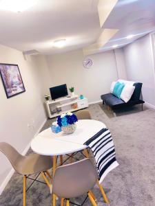 a living room with a table and chairs and a couch at ClassicPavillion INN in Bowmanville