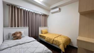 a small bedroom with a teddy bear sitting on a bed at HOMESTAY WITH 2 BEDROOMS IN NILAI for Malaysian traveler in Nilai