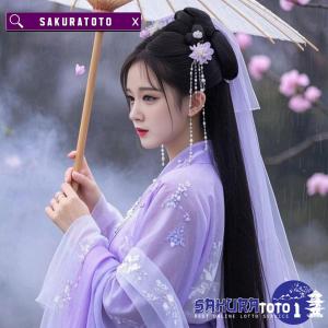 a woman in a purple dress holding an umbrella at Sakuratoto in Mengwi