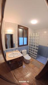 a bathroom with a sink and a toilet and a mirror at El Bosque Nomada 4 in El Bosque +11 photos