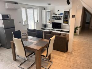 a kitchen and living room with a table and a couch at Ana`s place in Celje
