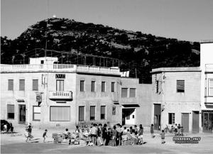 a group of people standing in front of a building at Apartamentos Loar in Ferreries