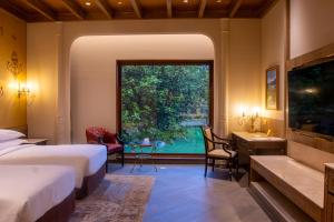 a bedroom with two beds and a large window at The Soaltee Kathmandu, Autograph Collection in Kathmandu